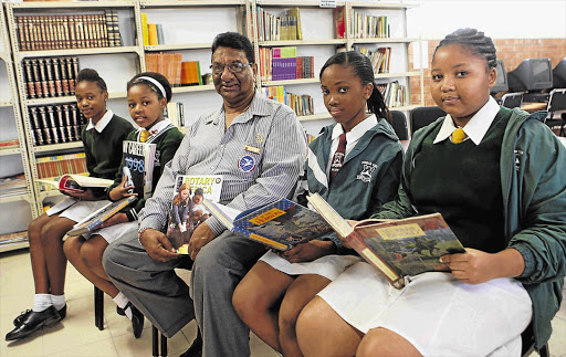 WORD WISE: Pupils of Durban South Primary Ntokozo Cebekhulu, Siphokazi Zulu, Nomzamo Mabaso and Sanelisiwe Buthulezi with Gona Naidoo, who helped build the library