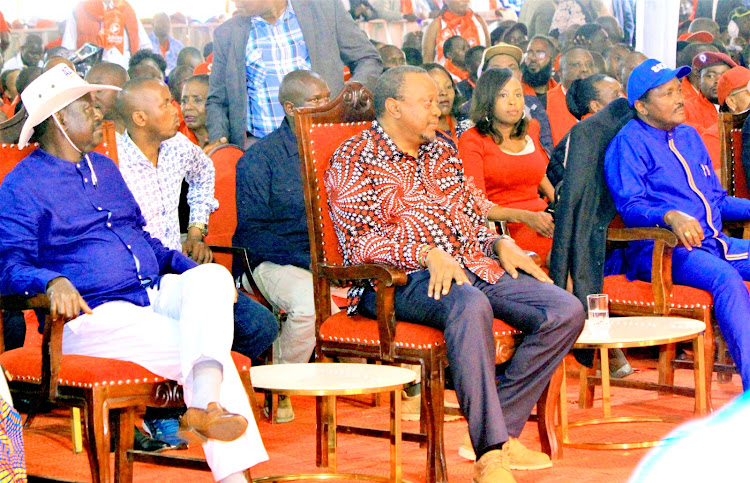 ODM party leader Raila Odinga, Jubilee party leader Uhuru Kenyatta and Wiper party leader Kalonzo Musyoka follow proceedings during the Jubilee party National Delegates Conference at Ngong Racecourse on May 22, 2023.