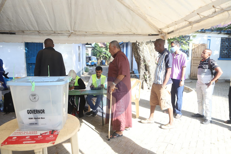 Voters queue to vote for the governor polls at Mwenbe Tayari PHD polling Station, Mvita, Mombasa on August 29, 2022.