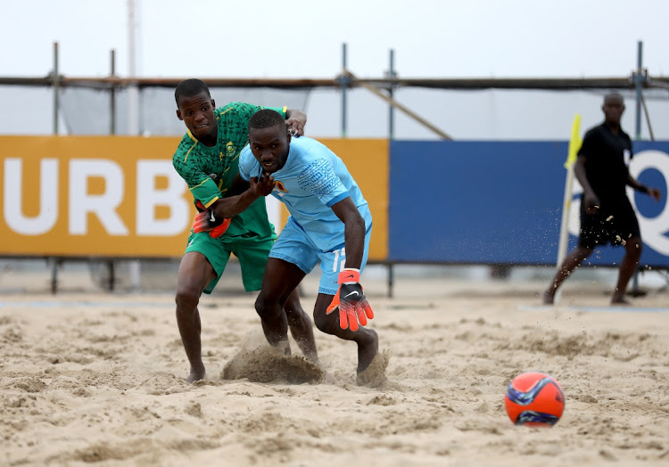 Xolani Hlela of South Africa challeges Angolan goalkeeper Joaquim Sardinha during the COSAFA Beach Soccer Tournament in Durban.