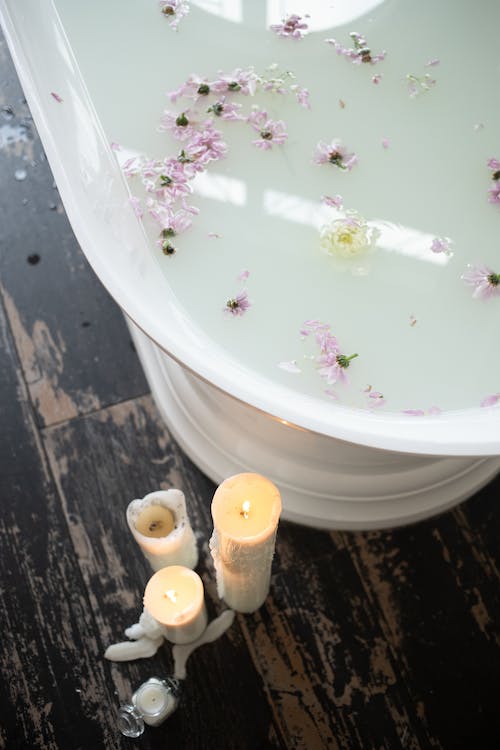 Free Bathroom with candles and white water with flower petals Stock Photo
