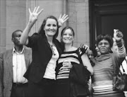 15/13/2010.Gaby Burgmer, daughter of Franz Richter, an 80-year-old man who was murdered at his Heia Safari Lodge in Muldersdrift, Johannesburg, and Gaby's daughter, Bianca Burgmer,celebrate outside  the Johannesburg  High Court after 

four people accused of his murder  were given life sentences. Pic. VATHISWA RUSELO. 15/03/2010. © Sowetan.