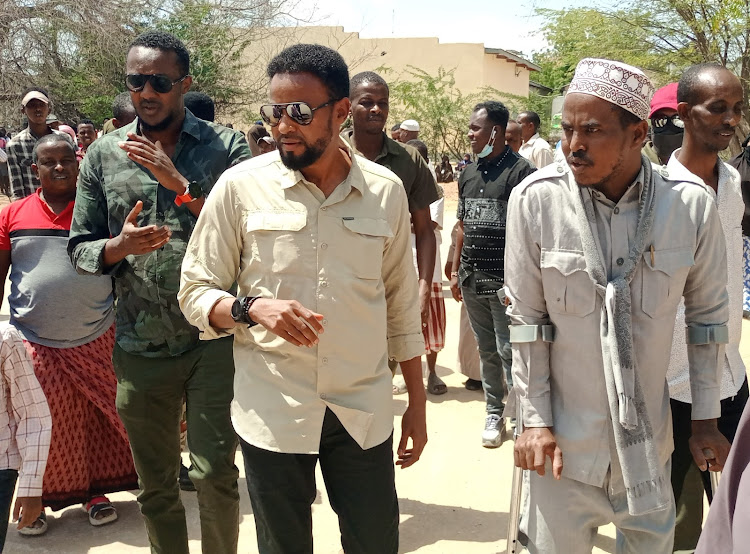 Garissa Senator Abdul Haji interacts with voters at the Garissa Primary polling station on Tuesday, August 9.