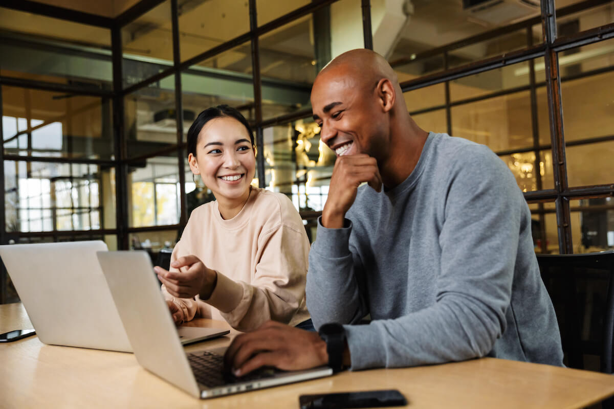 Employee wellness: 2 people happily working together