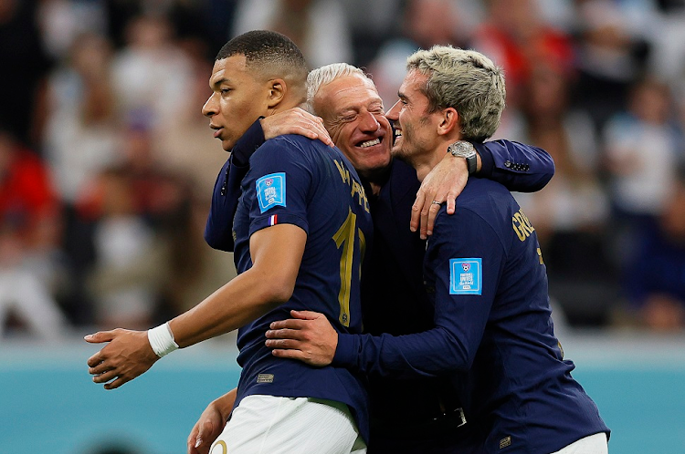 France coach Didier Deschamps celebrates with players Kylian Mbappe (left) and Antoine Griezmann after winning their World Cup quarterfinal against England at Al Bayt Stadium in Al Khor, Qatar on December 10 2022.