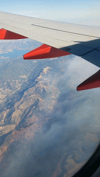 Fires adding lots of smoke to the air during my flight from Portland to Oakland on October 12, 2017. Smoke seen from airplane of wildfires in California.