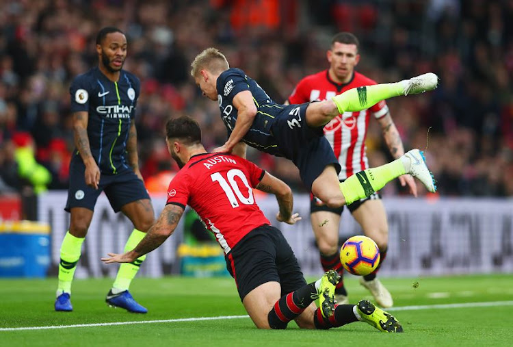 Oleksandr Zinchenko of Manchester City and Southampton's Charlie Austin tangle during their Premier League match at St Mary's Stadium on Sunday. City bounced back from a bad patch to beat the Saints 3-1.