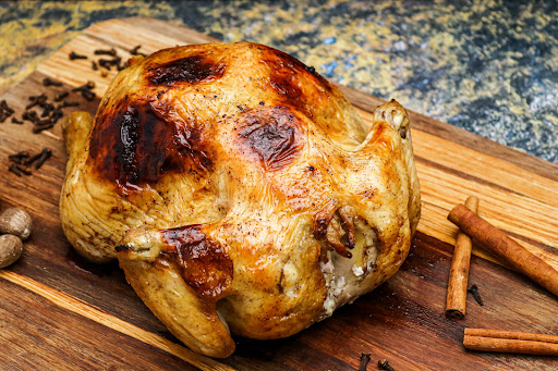 Unique Roasted Chicken on a cutting board.