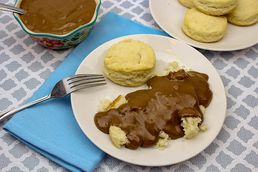 A bowl of Shawn's chocolate gravy with some poured over biscuits.