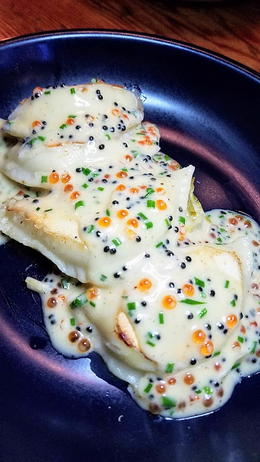 Dinner at Delores PDX: Potato truffle pierogis, braised leeks, caviar beurre blanc