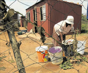 LIVING ON BORROWED TIME: Busisiwe Mtolo does not know that her leaking tap  could lead to her being swallowed by the ground. Water and dolomite do not mix.