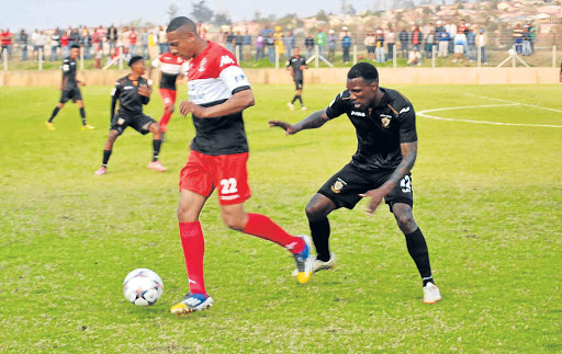 TOUGH GAME: A Vasco Da Gama player, left, and his Mthatha Bucks opponent tussle for the ball during their National First Division match in Mthatha at the weekend. The game ended in a 1-1 draw Picture: LOYISO MPALANTSHANE