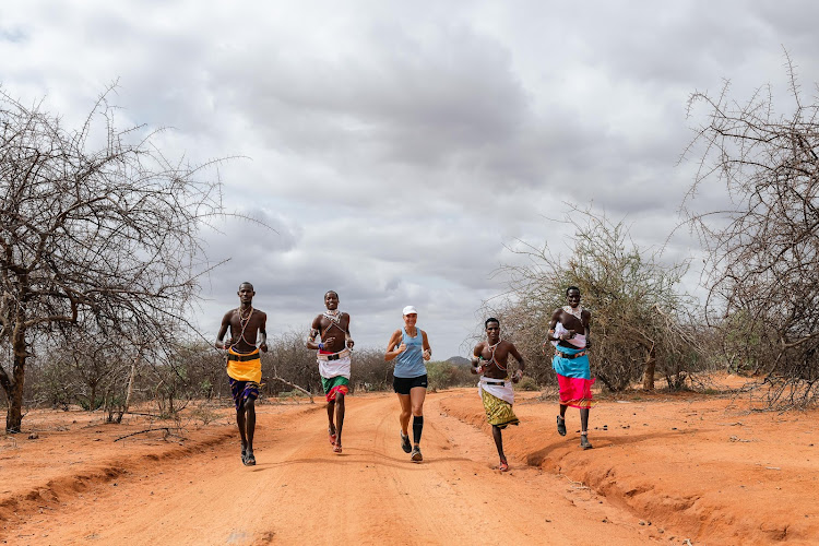 Mina Guli, founder and CEO of Thirst Foundation, running marathon number 48 with Samburu warriors in Kenya during the Run Blue campaign to raise awareness, create urgency and drive action on water.