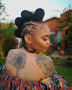 A Soweto Ink client shows off the ink on her back.