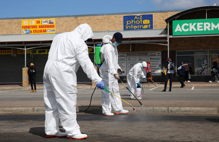 Nelson Mandela Bay municipality public health officials disinfect the area in and around the Ziyabuya Mall, in Kwadwesi, on Monday