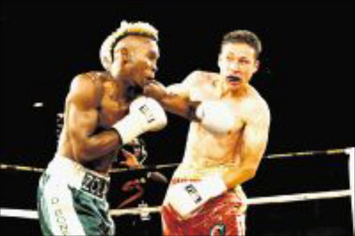 WIDE OPEN: Zolani Marali delivers a deadly left hook to Gamali Diaz's jaw during their IBO junior lightweight bout in Johannesburg recently. Marali will defend his title against Ji Hoon Kim on September 12. Pic: ANTONIO MUCHAVE. 03/04/2009. © Sowetan