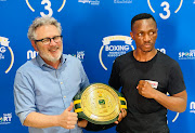 SABC Sport GM Garry Rathbone poses with reigning SA lightweight champ Tshifhiwa Munyai afdter his third round knockout of Sanele Msimnago on Sunday.
