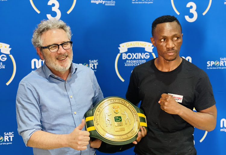 SABC Sport GM Garry Rathbone poses with reigning SA lightweight champ Tshifhiwa Munyai afdter his third round knockout of Sanele Msimnago on Sunday.