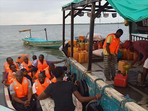 A boat operator gets his boat fuelled in Lamu town.