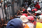 Protesting students attempt to force their way onto the University of the Witwatersrand campus in Johannesburg on March 3 2023.