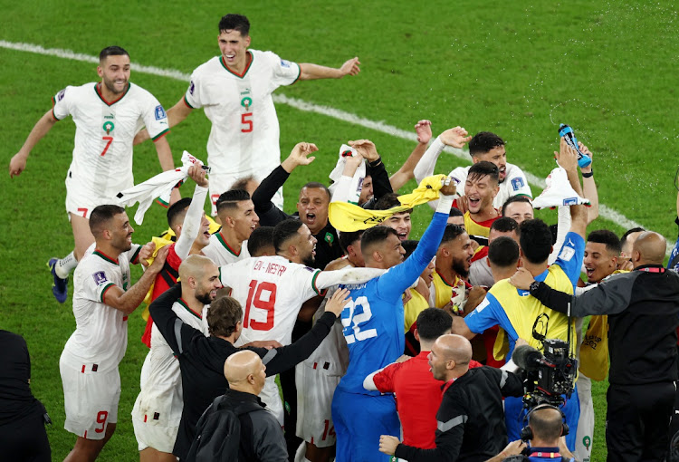 Morocco's players celebrate after betaing Canada Al Thumama Stadium in Doha, Qatar to qualify for the World Cup knockout stages.