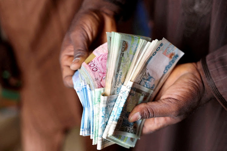 A man counts Nigerian naira notes in a market place in Yola, Nigeria, on February 22 2023. File photo.