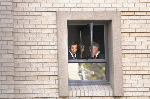 Oscar Pistorius looks out of the Pretoria High Court building, where final arguments in his murder trial are being heard.