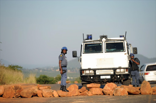 Police standing next to a Nyala