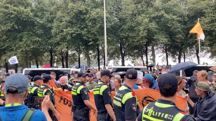 Climate activists protest in The Hague, Netherlands, September 11, 2023, in this screen grab obtained from a social media video.