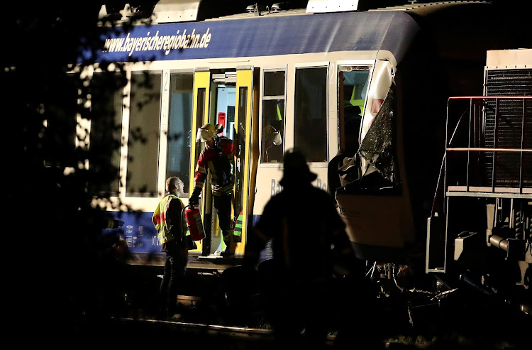 Firefighters and paramedics work at the scene where two trains collided in Aichach near Augsburg, Germany May 8, 2018.