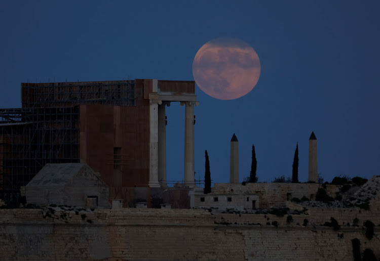 The full moon, known as the hunter's moon, rises behind the ancient Rome film set for Ridley Scott's film "Gladiator 2" during the Hollywood actors' strike, at Fort Ricasoli in Kalkara at the entrance to Valletta's Grand Harbour, Malta October 28, 2023.