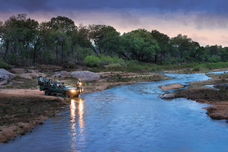 A game drive crossing the river at the Tengile River Lodge.