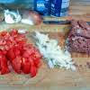 Thumbnail For Onions, Tomatoes, And Corned Beef Chopped On A Cutting Board.