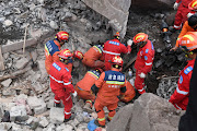 Rescue workers search for survivors in the debris after a landslide hit Zhenxiong County, in Zhaotong, Yunnan province, China January 22, 2024. 