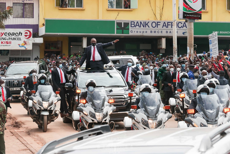 President Uhuru Kenyatta acknowledges greetings from Kisii town residents en route to Gusii Stadium for this year's Mashujaa Day celebrations on October 20, 2020.