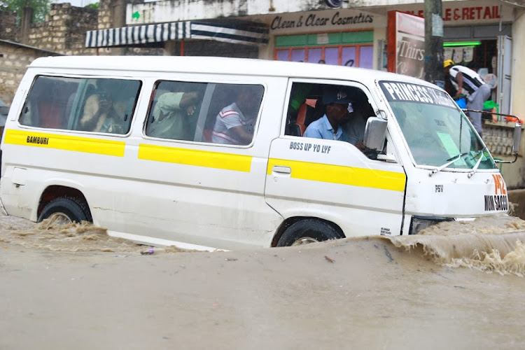 SWEPT UNDER MAT: A matatu wades through flash floods at Bamburi in Mombasa on October 13 Image: JOHN CHESOLI