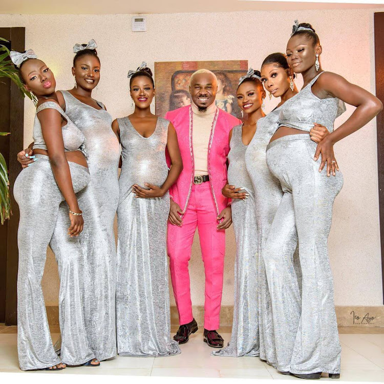 Socialite Pretty Mike posses with his six pregnant women