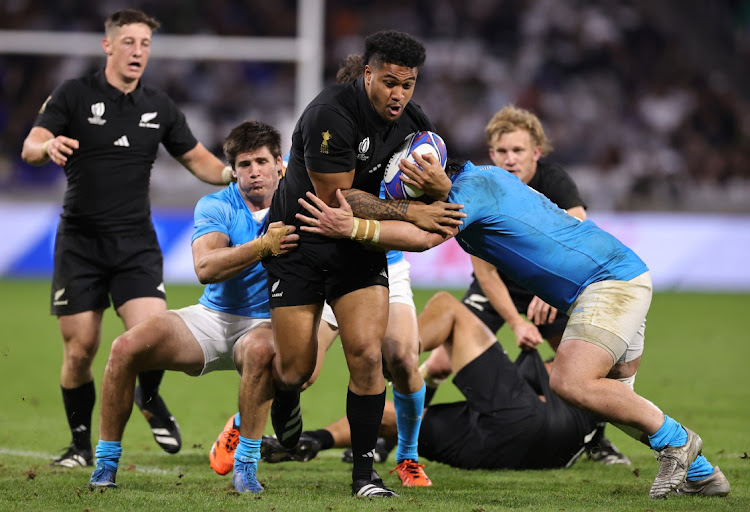 Leicester Fainga'anuku of the All Blacks is tackled by German Kessler (right) and Tomas Inciarte of Uruguay in the Rugby World Cup pool A match at Parc Olympique in Lyon on Thursday night.