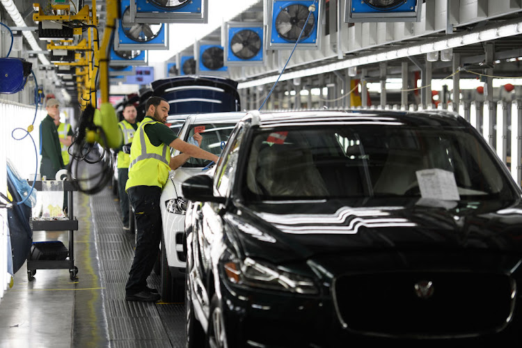 Vehicles are checked before moving to the next stage of production at the Jaguar Land Rover factory in Solihull, England.