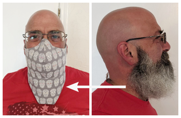 A man shows off a mask covering his beard