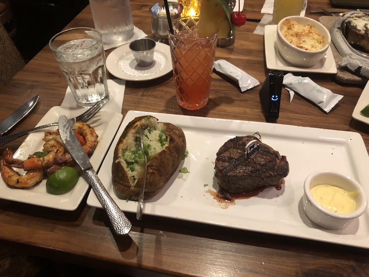 Filet mignon, baked potato. I did not eat or test the bernaise sauce. I'd stay away from that. Shrimp and steak were SOOO good! Oh and the drink is the Texas punch (titos, malibu, pineapple juice, cranberry juice and a texas flag topper haha) nom nom so good.