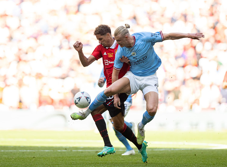 Manchester United's Raphael Varane vies for the ball with Manchester City's Erling Haaland during a past FA Cup match