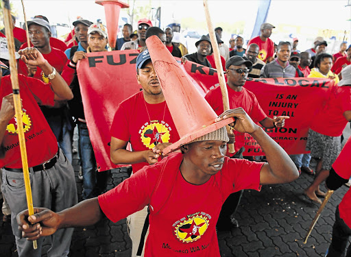 UP IN ARMS: Numsa members blockade the entrance to an Engen garage in Germiston as they picket outside the garage this week.