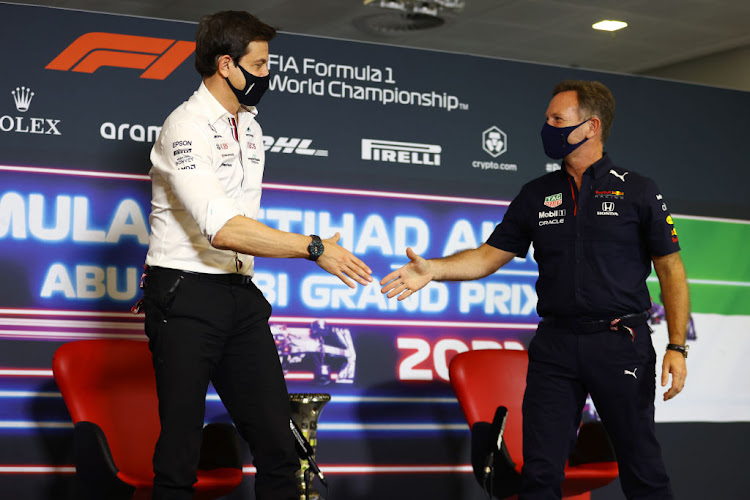 Toto Wolff and Christian Horner shake hands in a press conference ahead of the F1 Grand Prix of Abu Dhabi on December 10 2021 in Abu Dhabi, United Arab Emirates.