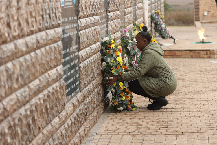 Lerato Sejake, one of the family members who lost their loved ones in the line of duty, lays wreaths in Bloemfontein.