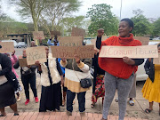 Family and community members demonstrate outside the Pinetown magistrate’s court on Monday with placards urging no bail for policeman Sgt Ayanda Ntombela, accused of the murder of Sihle Mtshare.