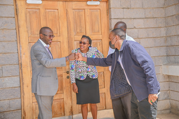 Sacco Societies Regulatory Authority CEO Peter Njuguna, is received by Acumen Sacco CEO Moses Mathu and Kajiado North Sub-County Cooperatives Officer Salome Wangui for the society's 15th AGM held on Saturday at the Catholic University auditorium.