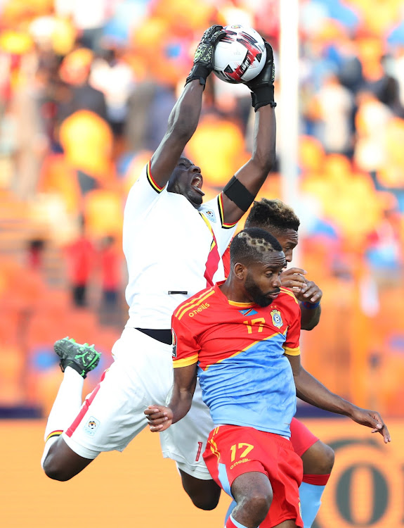 Uganda's Denis Onyango in action with DR Congo's Britt Assombalonga and Cedric Bakambu