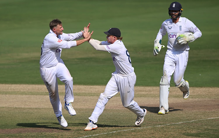 England bowler Joe Root celebrates with Ollie Pope after taking the wicket of KL Rahul after a review on day four of the first Test against India at Rajiv Gandhi International Stadium in Hyderabad, India on Sunday.