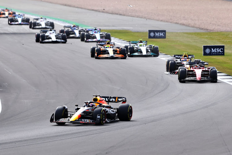 Max Verstappen leads a line of cars during the British F1 Grand Prix at Silverstone.